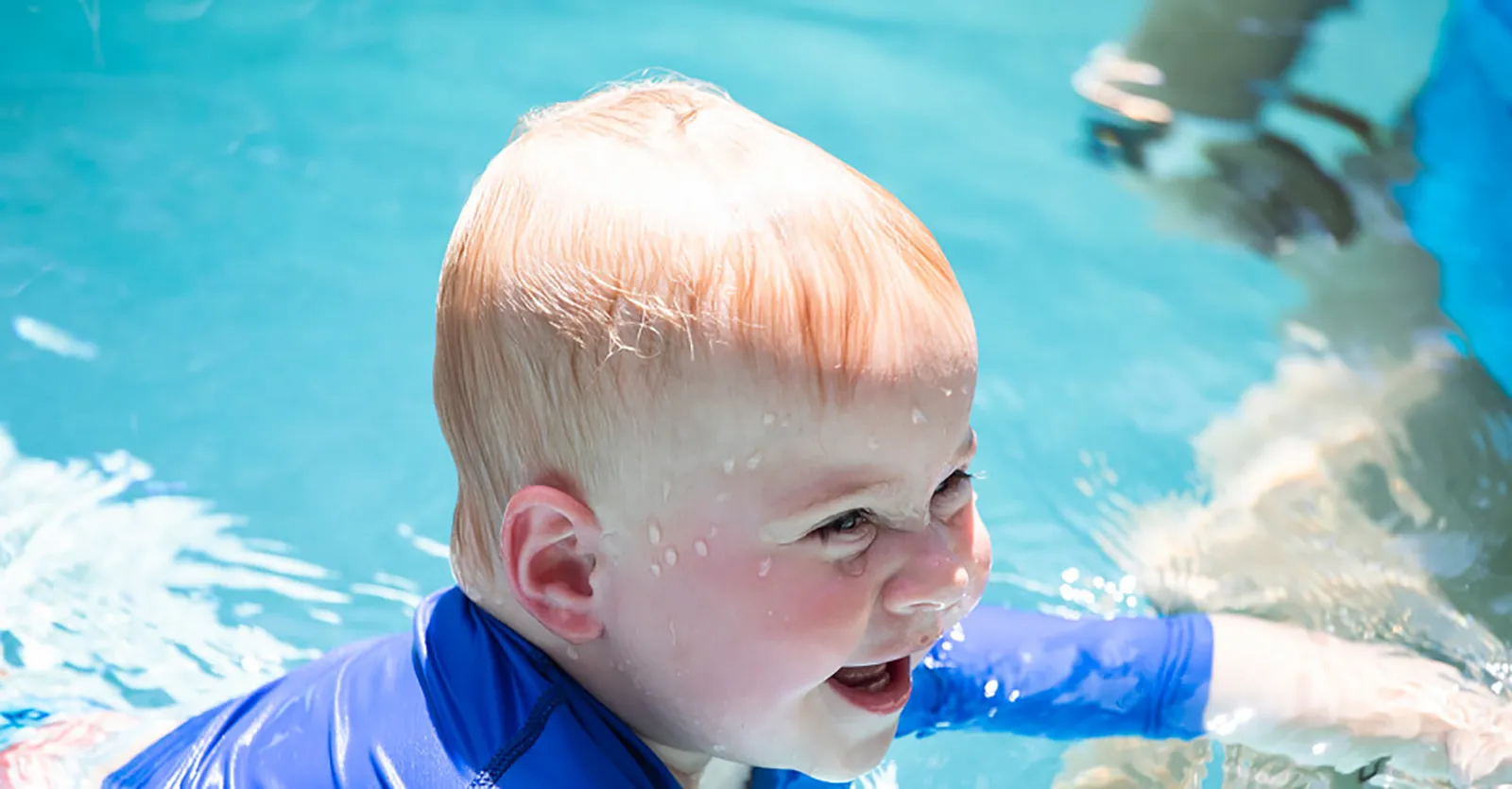 Boy in Pool Smiling blond boy at the edge of the pool after a swim lesson